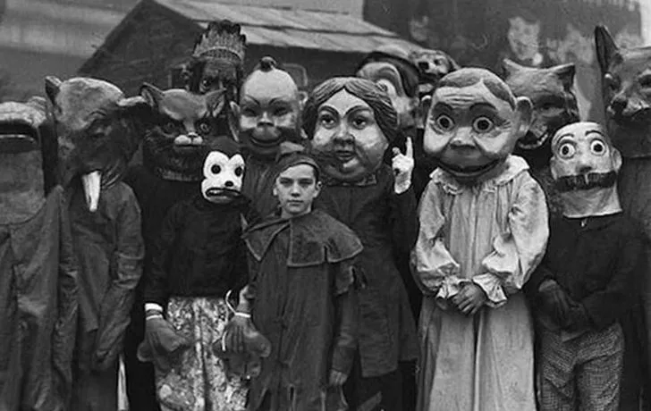 Greyscale photo of a group of people wearing horrifying costumes.
