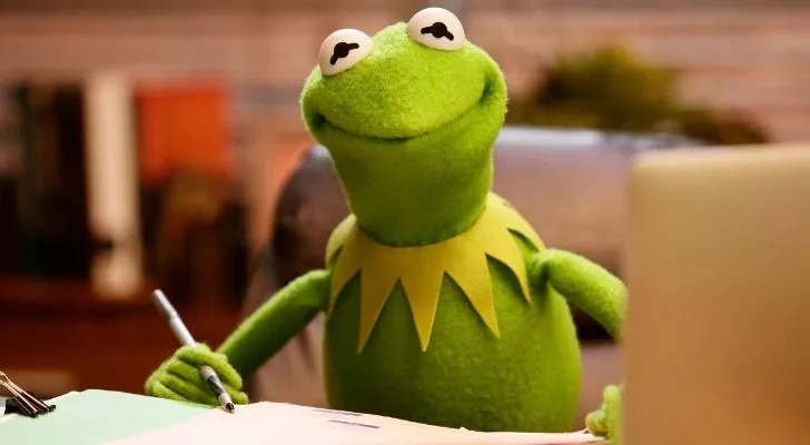 Kermit writing at a desk