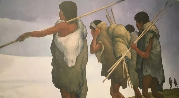 Three Paleo-Indians walking