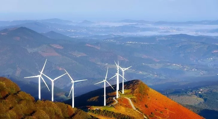 Wind turbines on top of a hill.