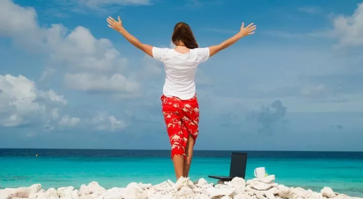 A woman on the beach with her laptop